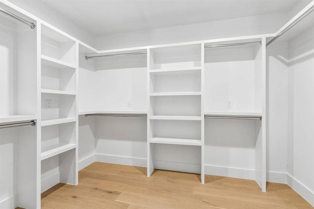 7124 Meadow Road, Dallas, TX 75230 One of two closets in the primary suite,complete with shelving.