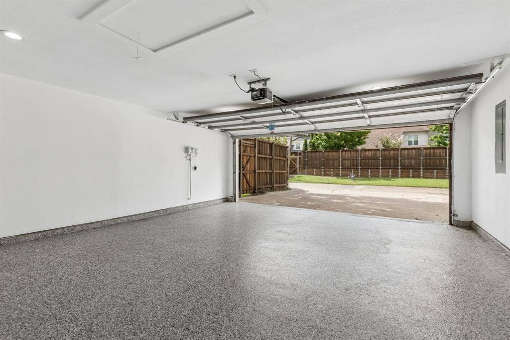7124 Meadow Road, Dallas, TX 75230 Large garage,epoxy floor,and three parking spots behind the garage