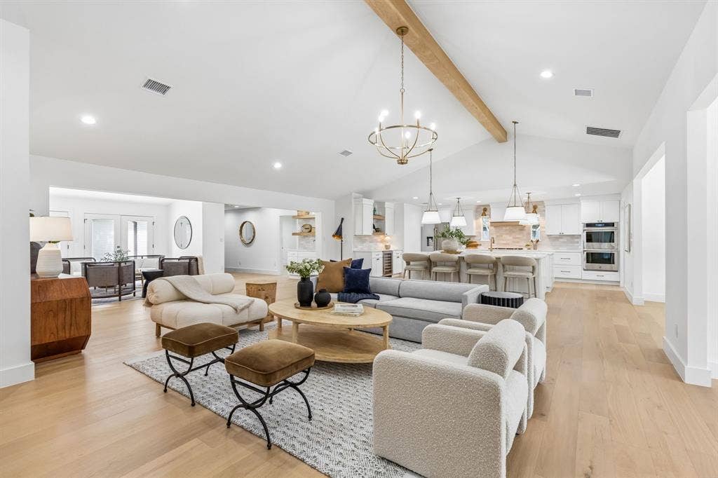 7124 Meadow Road, Dallas, TX 75230 Expansive versatile room with beam ceiling,fireplace,and open to kitchen