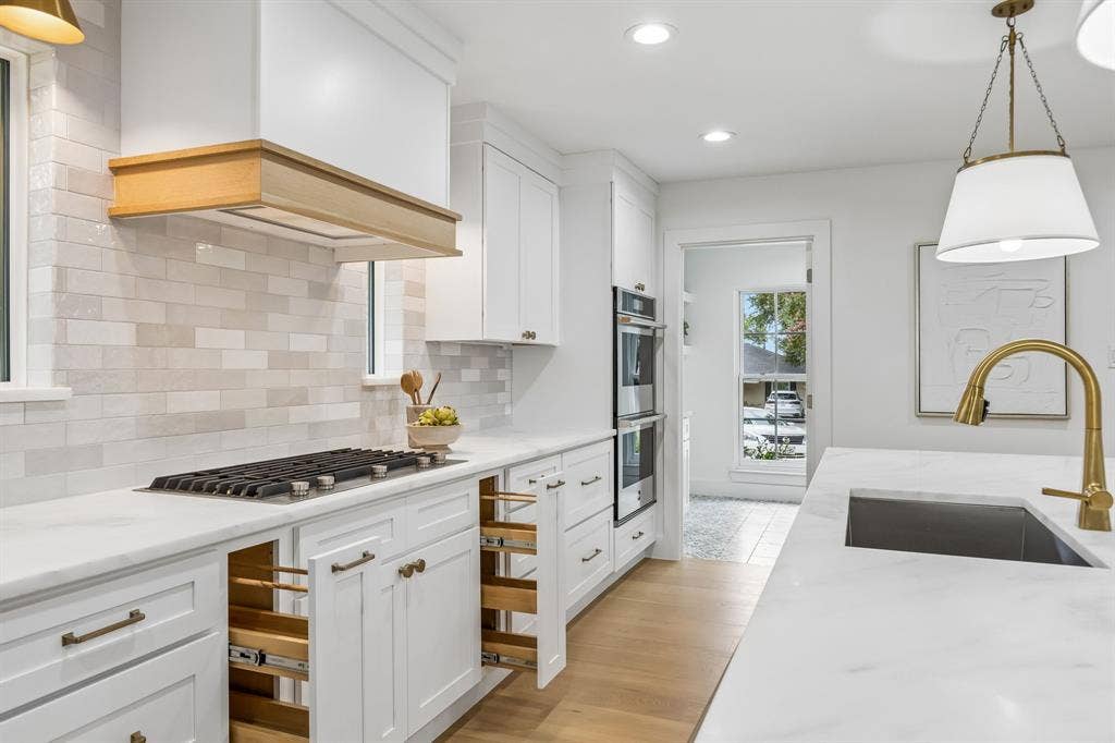 7124 Meadow Road, Dallas, TX 75230 All the extras..spice drawers frame the cabinetry beneath the gas range