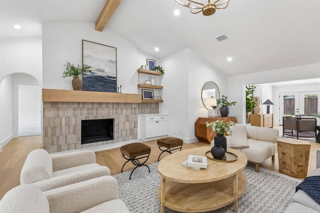 7124 Meadow Road, Dallas, TX 75230 Designer touches in the great room include the beamed ceiling,current light fixture,tile selection,and built ins.