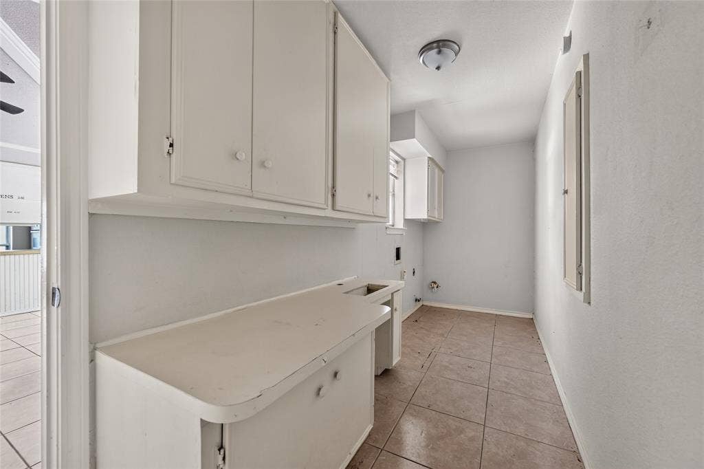 600 Terrace Drive, DeSoto, TX 75115 Utility area with tile flooring, white cabinetry, integrated countertop, and an overhead light fixture