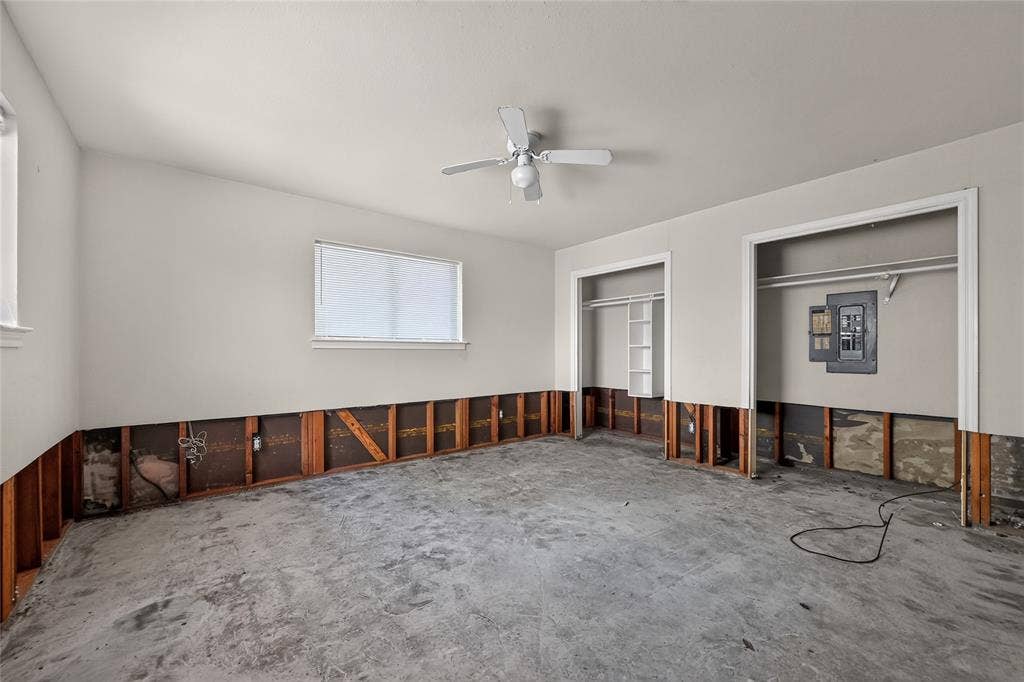 600 Terrace Drive, DeSoto, TX 75115 Room with exposed lower wall framing, two windows, and two closet openings