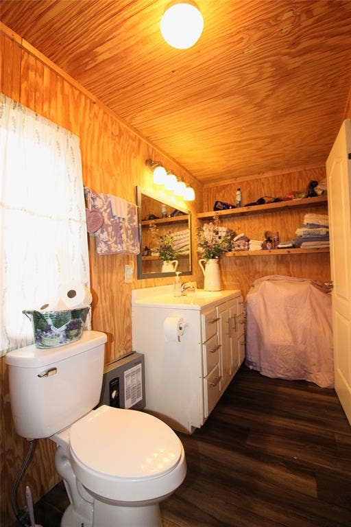 921 Crown Drive, Tool, TX 75143 Wood-paneled walls and ceiling in this bathroom featuring dark wood-finish flooring