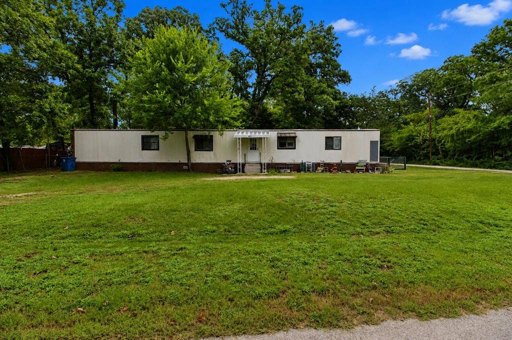 921 Crown Drive, Tool, TX 75143 Single-story residence with white siding and dark trim windows