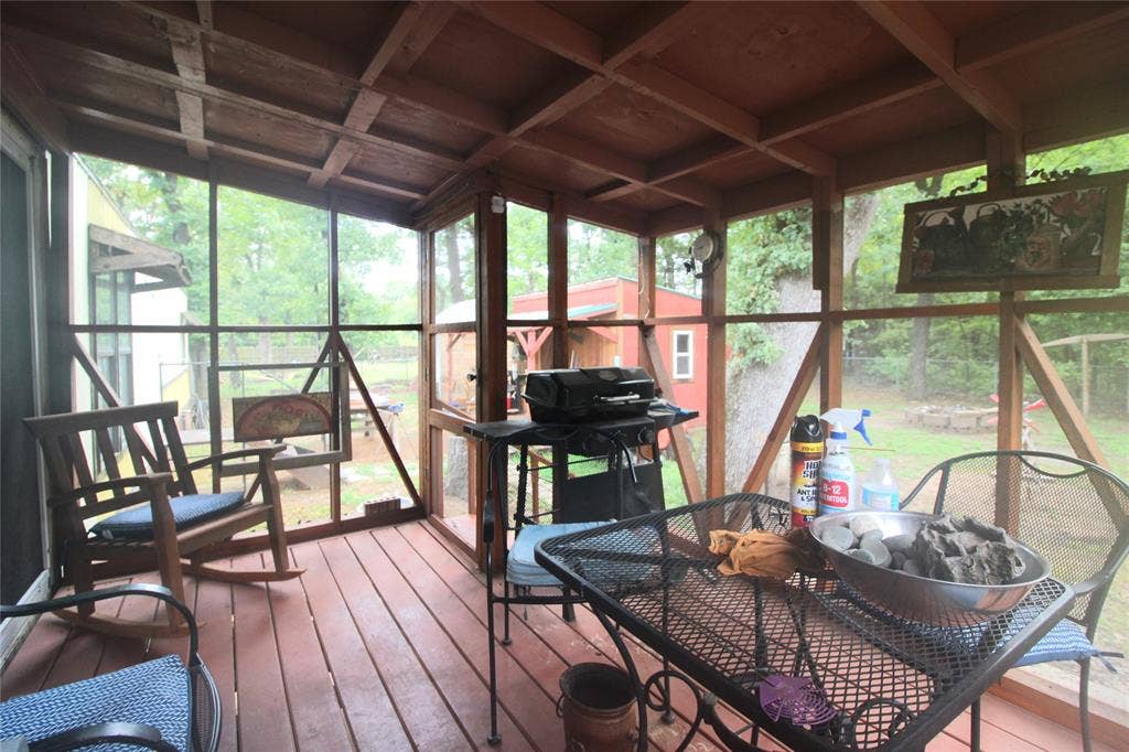 921 Crown Drive, Tool, TX 75143 Screened porch featuring a wood-finish ceiling, wood-finish flooring, and a screened door