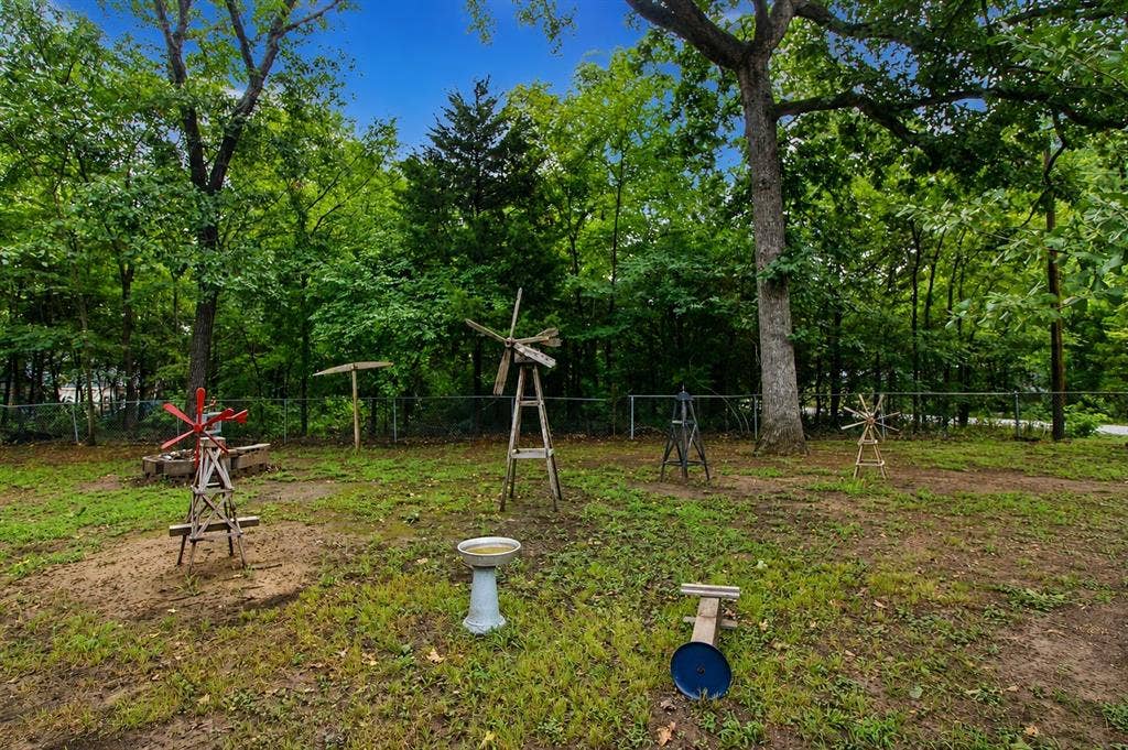 921 Crown Drive, Tool, TX 75143 Expansive green space featuring a variety of mature trees and a perimeter fence