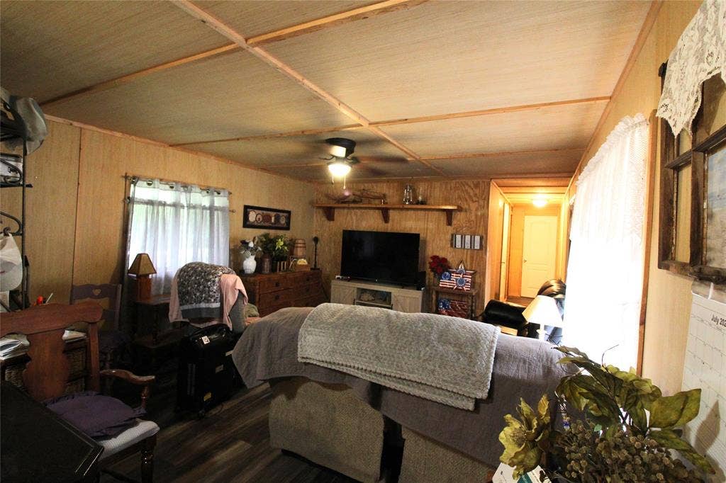 921 Crown Drive, Tool, TX 75143 Living area featuring wood-finish walls and complementary wood-finish flooring