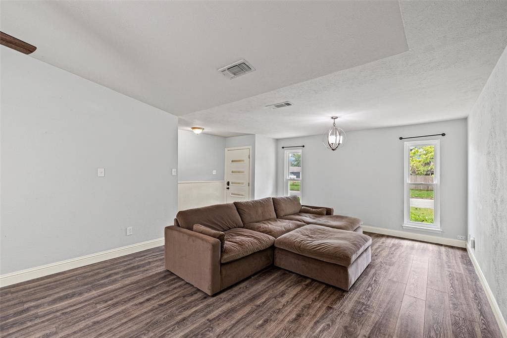 1005 Keller Avenue, Benbrook, TX 76126 Right off the front door, you're welcomed by a large living area ready for a cozy movie night!