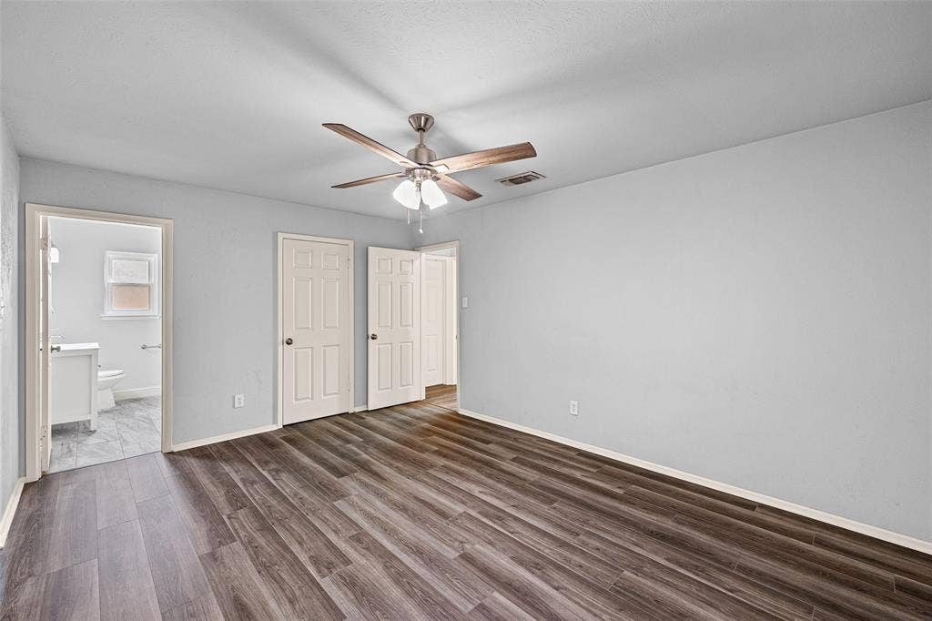 1005 Keller Avenue, Benbrook, TX 76126 Primary bedroom featuring new flooring, and en-suite bath.