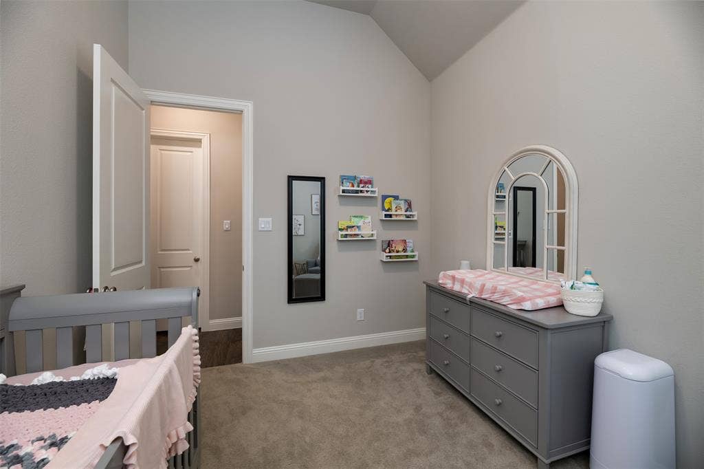 1109 10th Street, Argyle, TX 76226 Interior room featuring vaulted ceilings, light gray wall paint, and gray carpet flooring