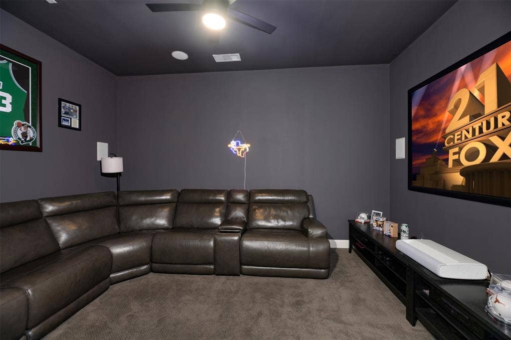 1109 10th Street, Argyle, TX 76226 Dedicated media room featuring a large wall-mounted screen, dark gray walls, recessed lighting, and a ceiling fan