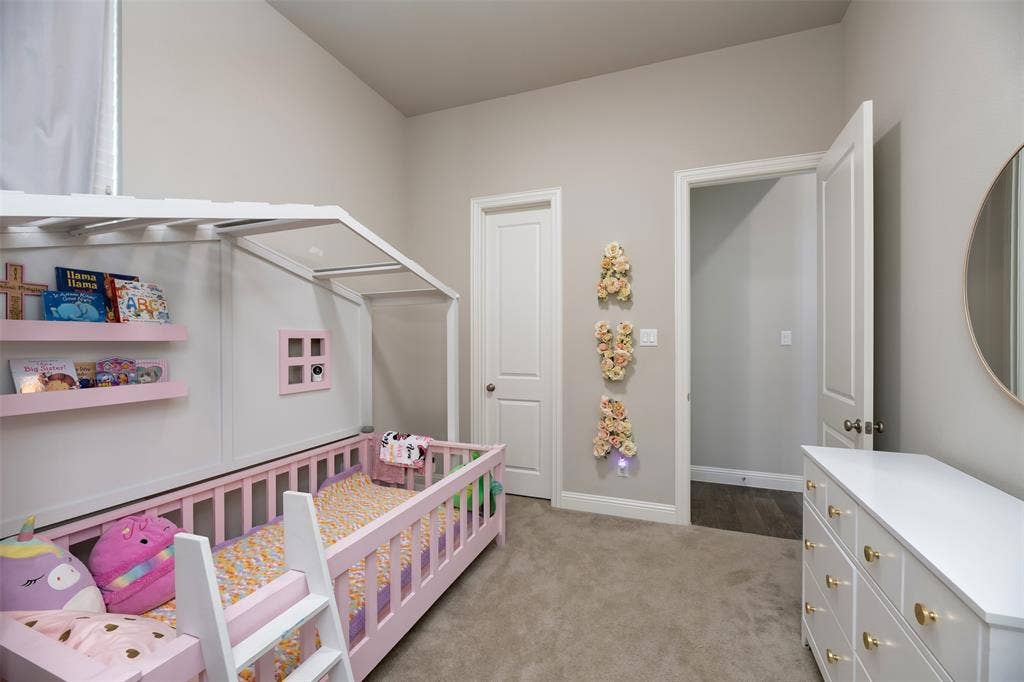 1109 10th Street, Argyle, TX 76226 Carpeted room featuring light gray walls, white trim, and a white six-drawer dresser with gold-toned hardware