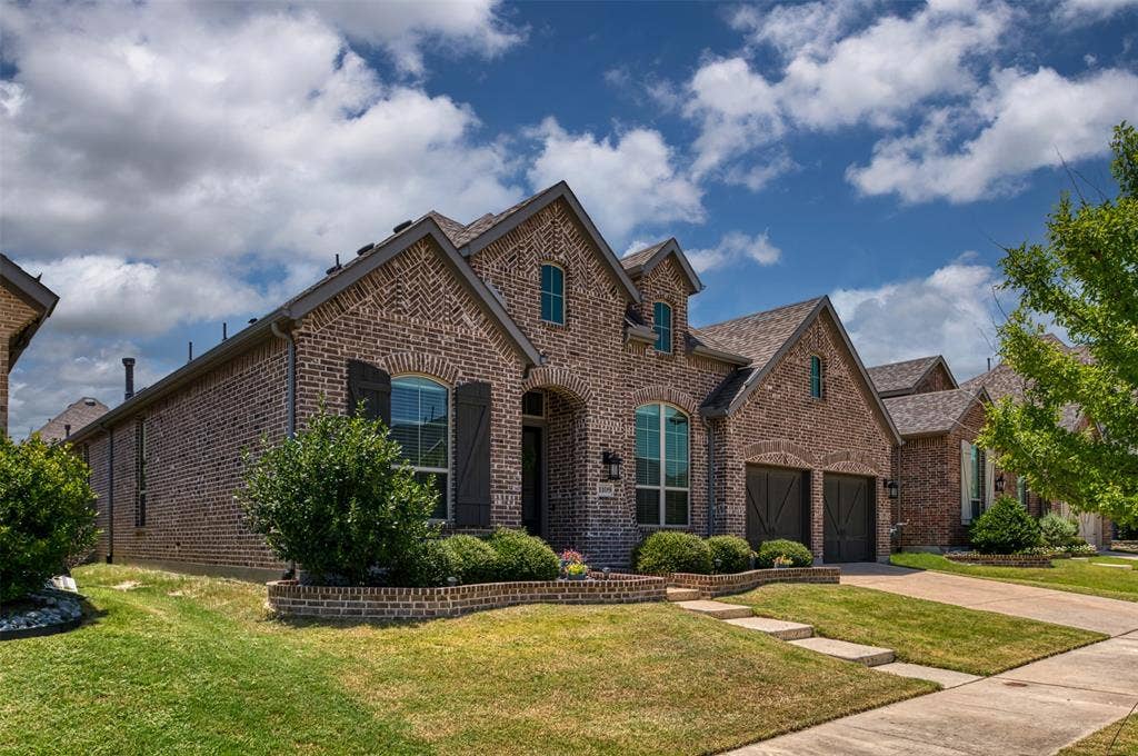 1109 10th Street, Argyle, TX 76226 Brick-clad exterior with gabled roof lines and dark-trimmed windows
