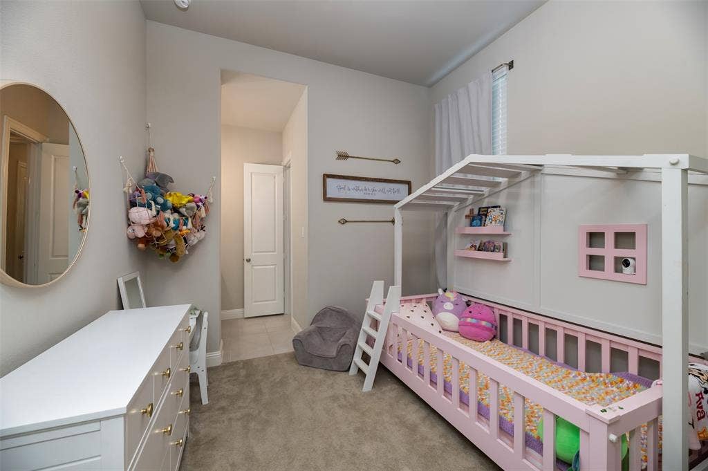 1109 10th Street, Argyle, TX 76226 Carpeted room with vaulted ceilings and neutral wall paint
