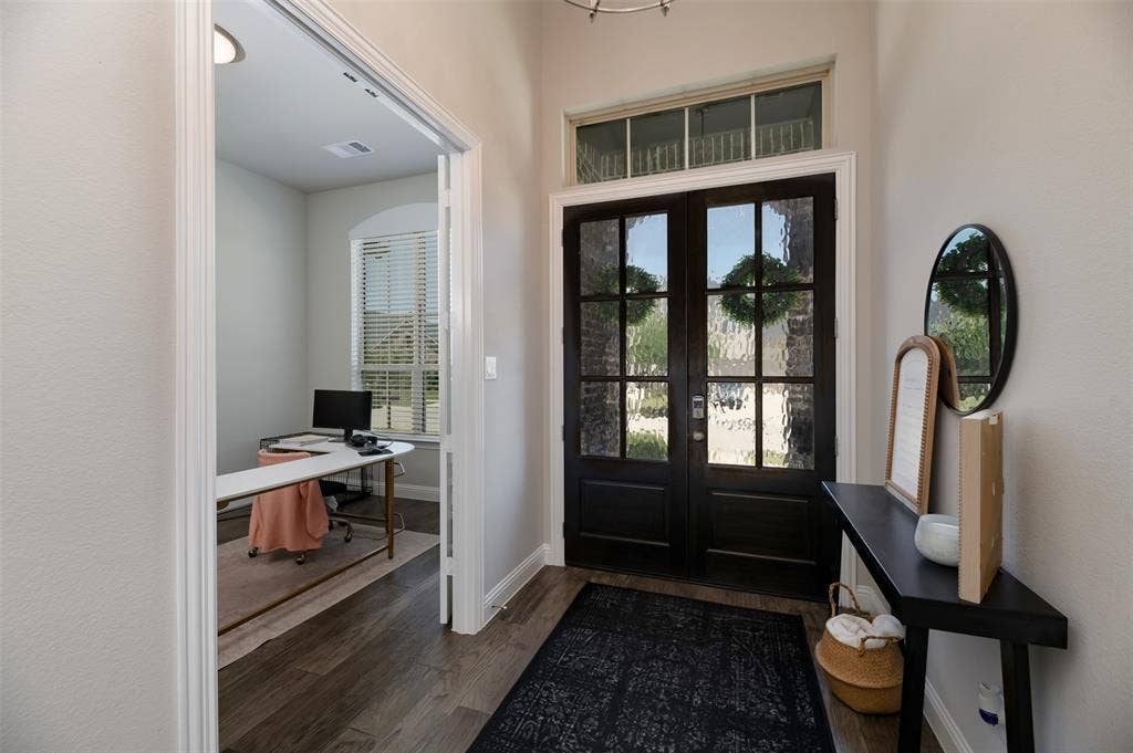 1109 10th Street, Argyle, TX 76226 Entryway featuring dark wood-finish double doors with textured glass panels and a transom window