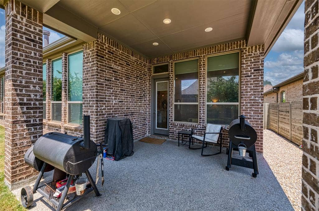1109 10th Street, Argyle, TX 76226 Covered patio featuring a granular-finish concrete surface and recessed lighting