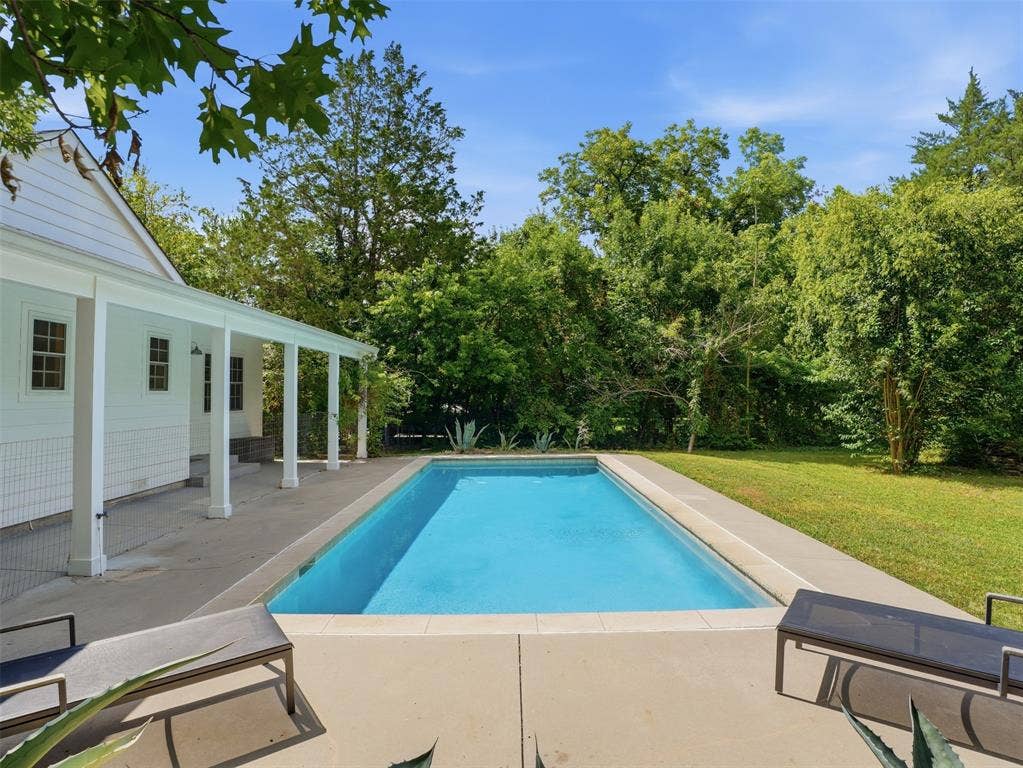 Rectangular swimming pool with a surrounding concrete patio