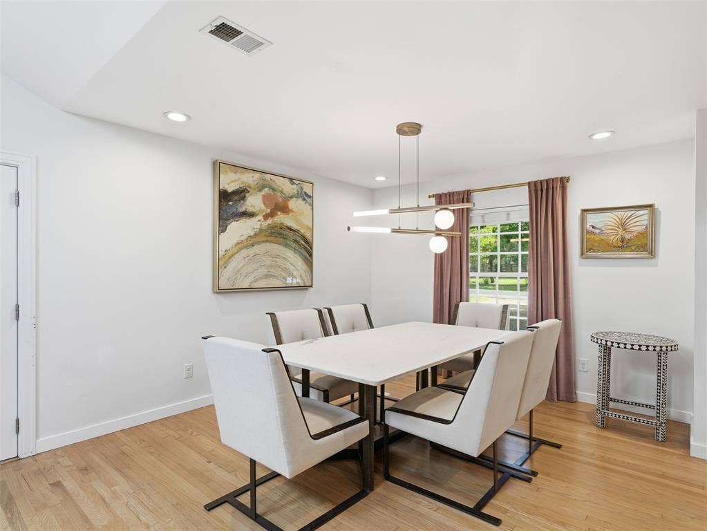Bright room featuring wood-finish flooring and recessed lighting