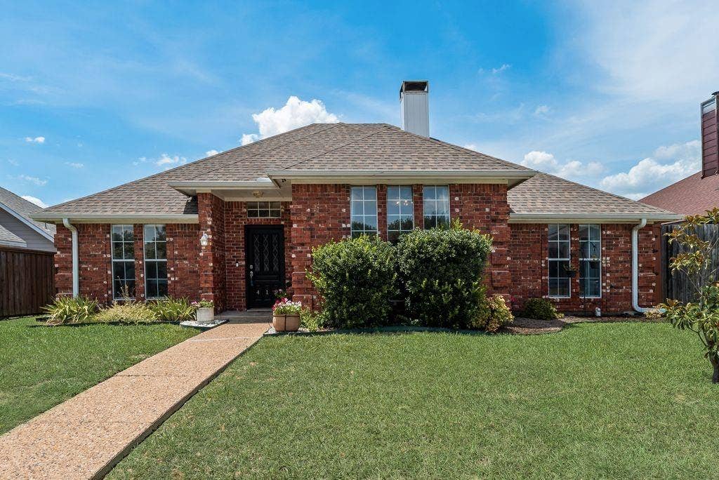 419 N Winding Oaks Drive, Wylie, TX 75098 Brick exterior featuring a gabled roofline, a front lawn, a paved walkway, and mature landscaping
