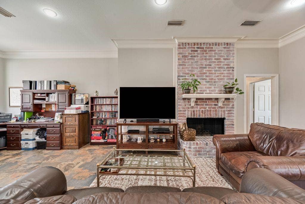 419 N Winding Oaks Drive, Wylie, TX 75098 Living room featuring a brick-surround fireplace with a white mantel, light gray walls, and recessed lighting