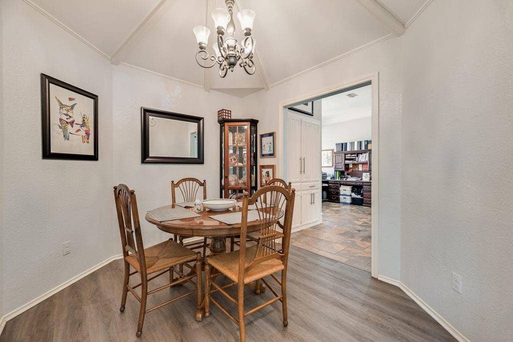 419 N Winding Oaks Drive, Wylie, TX 75098 Vaulted ceiling with an ornamental chandelier, wood-finish flooring, and white baseboards