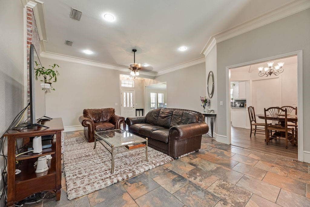 419 N Winding Oaks Drive, Wylie, TX 75098 Living area featuring slate tile flooring, recessed lighting, and crown molding
