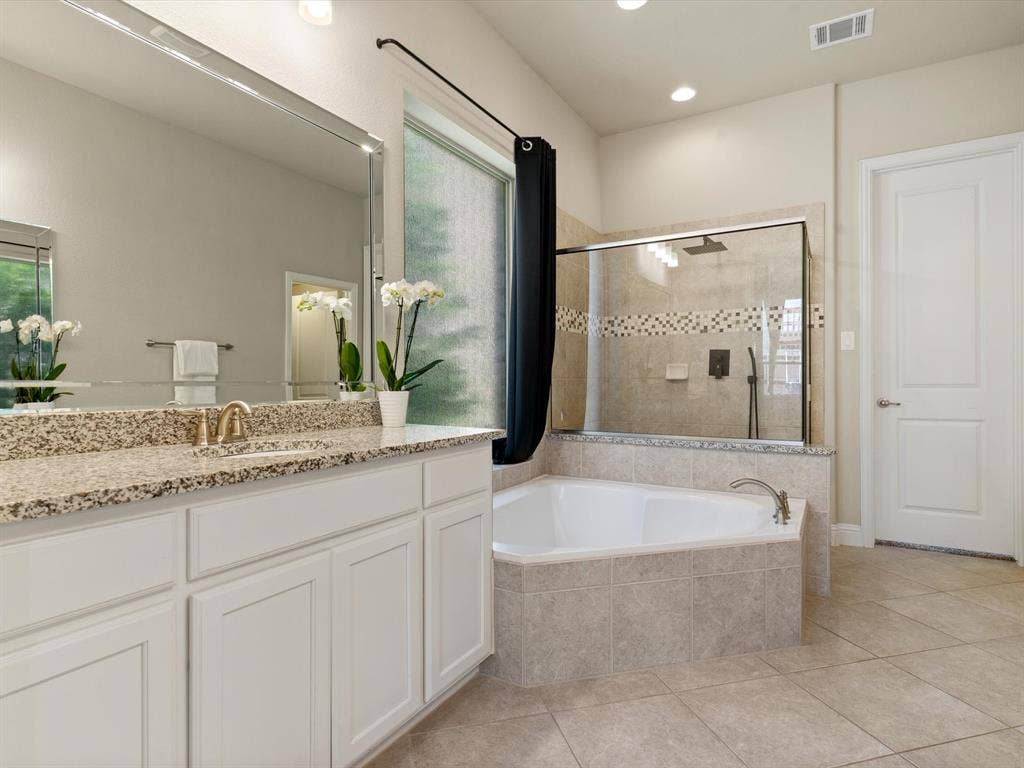 2703 Navarro Trail, Euless, TX 76039 Bathroom featuring a double vanity with stone countertop, white cabinetry, and an integrated rectangular mirror