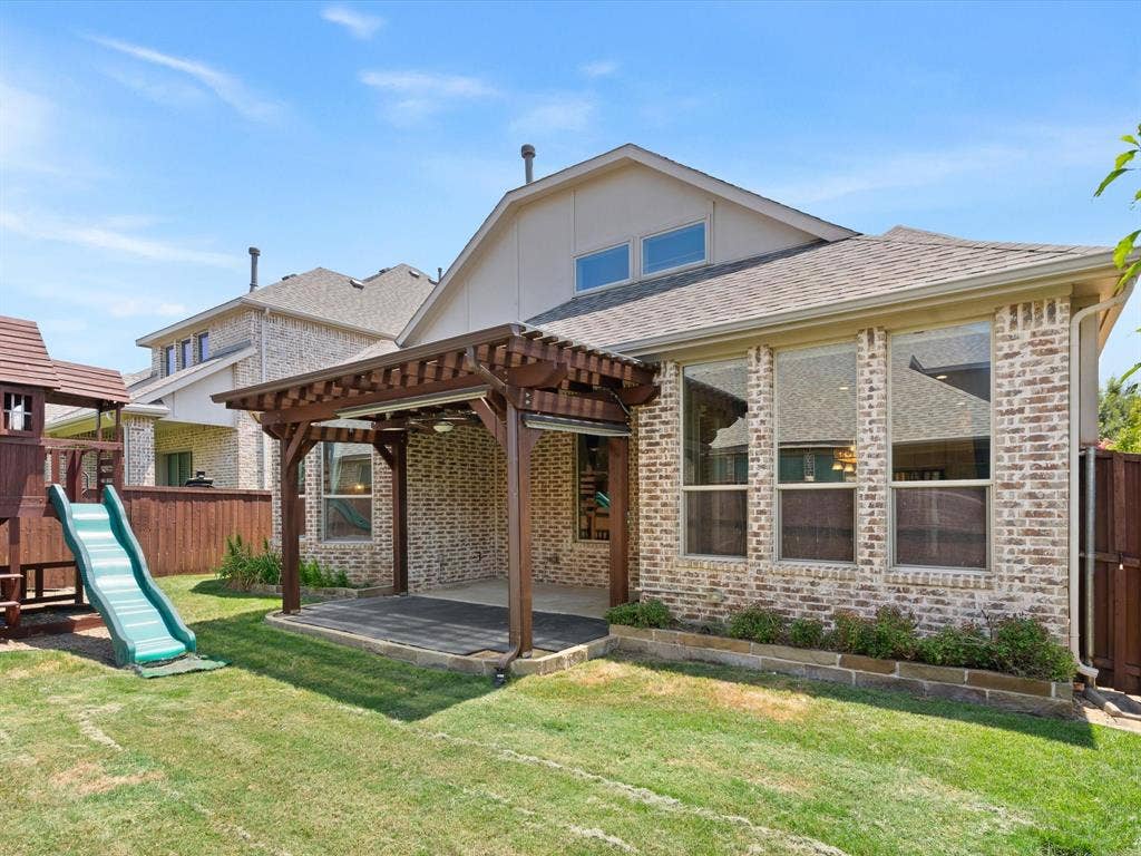 2703 Navarro Trail, Euless, TX 76039 Expansive rear exterior featuring a brick facade with an attached pergola-covered patio