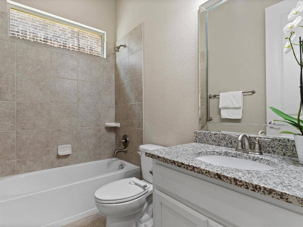2703 Navarro Trail, Euless, TX 76039 Bathroom featuring a white vanity with a granite countertop, with undermount sink, and brushed nickel faucet, first floor