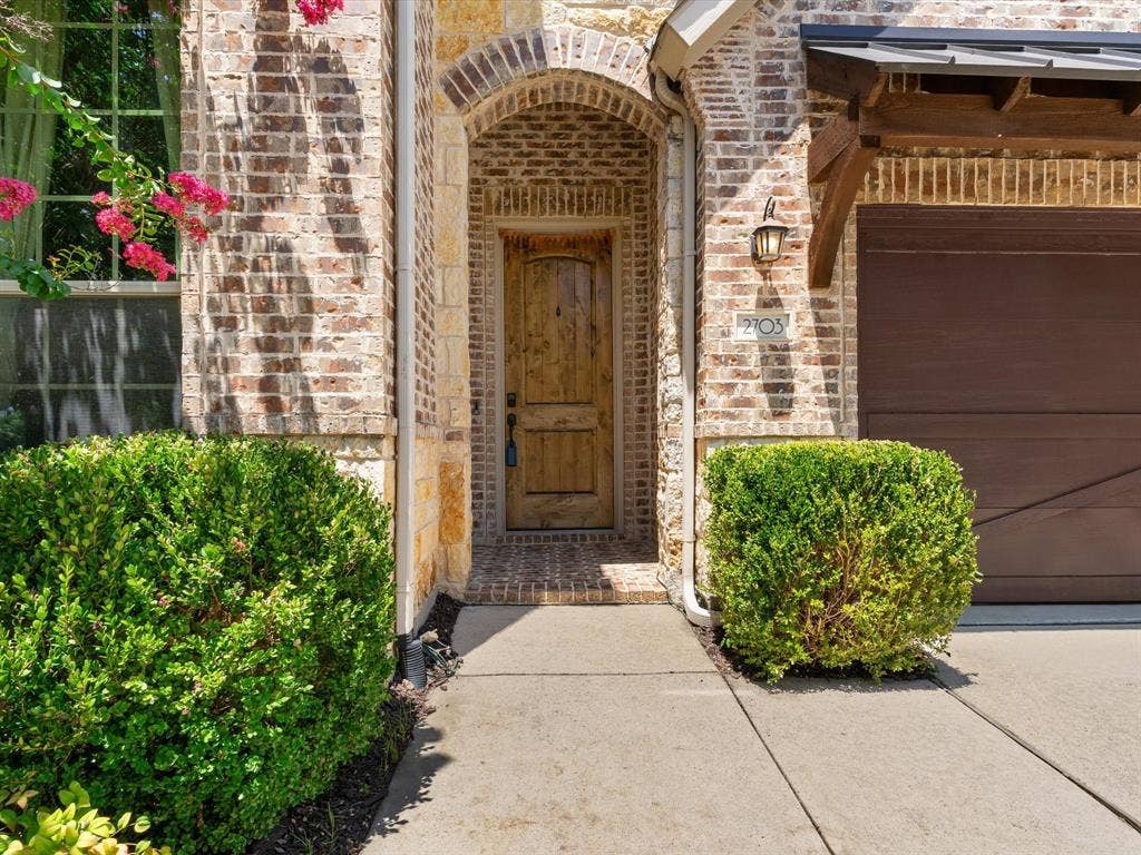 2703 Navarro Trail, Euless, TX 76039 Brick facade with stone accents and an arched entryway