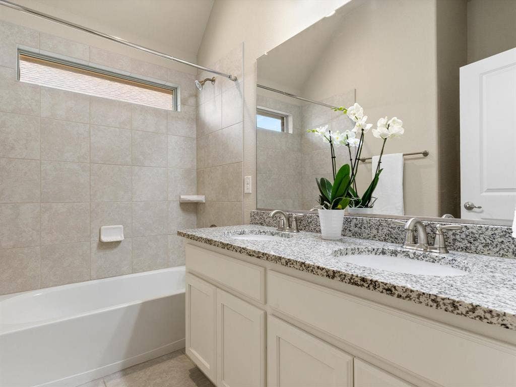 2703 Navarro Trail, Euless, TX 76039 Bathroom featuring a dual vanity with granite-finish countertops, undermount sinks, and brushed nickel fixtures, second floor