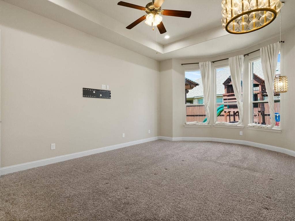 2703 Navarro Trail, Euless, TX 76039 Spacious room featuring a tray ceiling, recessed lighting, and a ceiling fan