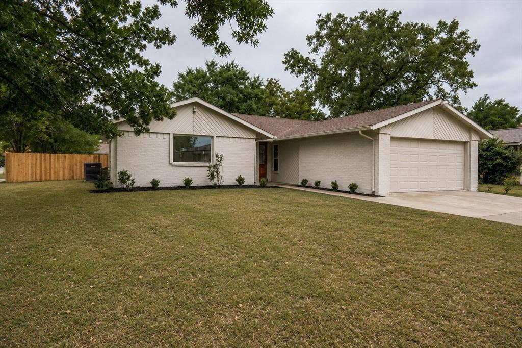 641 Stroud Lane, Garland, TX 75043 Single-story residence featuring a two-car garage, brick exterior, and a new privacy fence