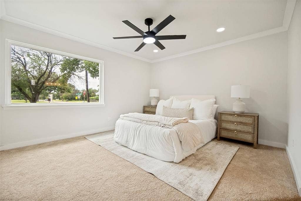 641 Stroud Lane, Garland, TX 75043 Spacious room featuring a large window, neutral carpeting, a modern black ceiling fan, and recessed lighting