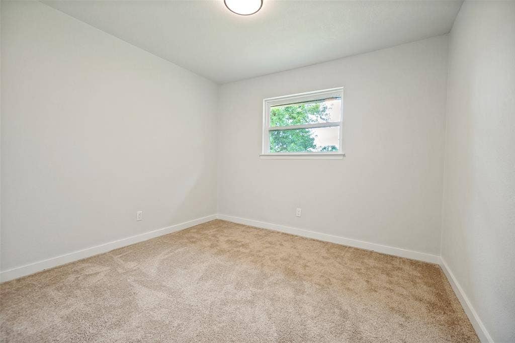 641 Stroud Lane, Garland, TX 75043 Neutral-toned carpeting paired with light walls and white baseboards