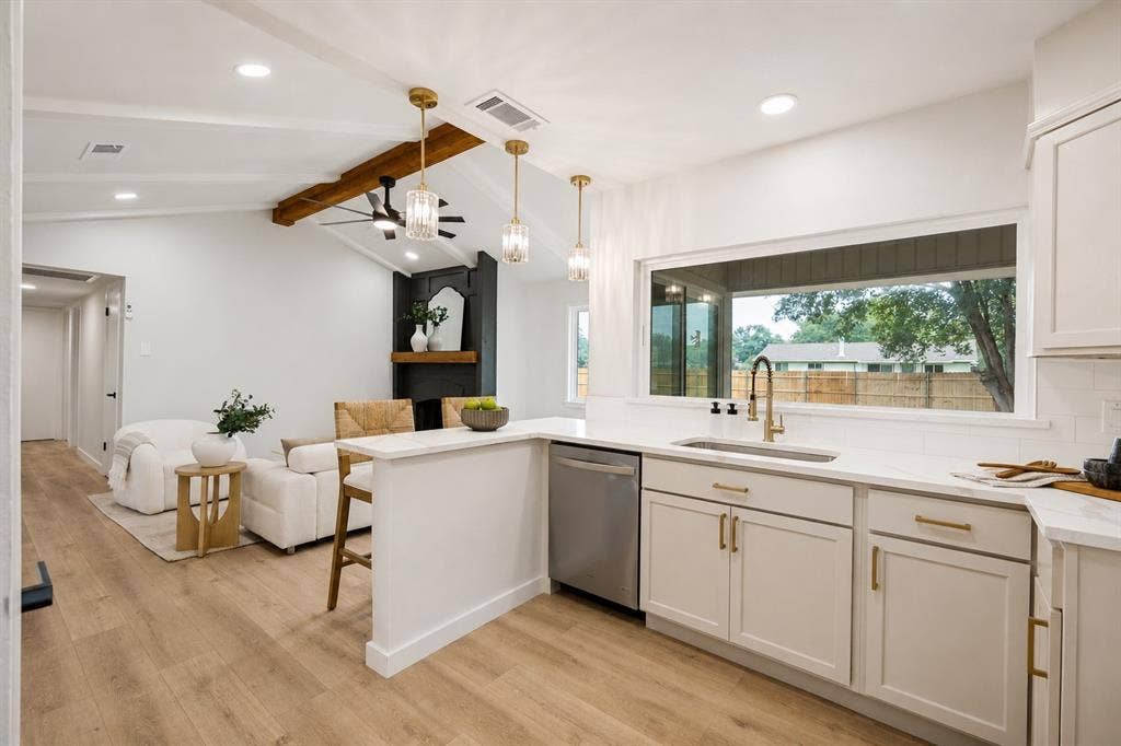 641 Stroud Lane, Garland, TX 75043 Open-concept kitchen and living area featuring a vaulted ceiling with exposed wood beam, recessed lighting, and wood-finish flooring