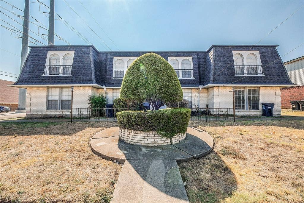 6317 Granbury Road, #6321, Fort Worth, TX 76133 Cream brick exterior featuring a mansard roof with dormer windows
