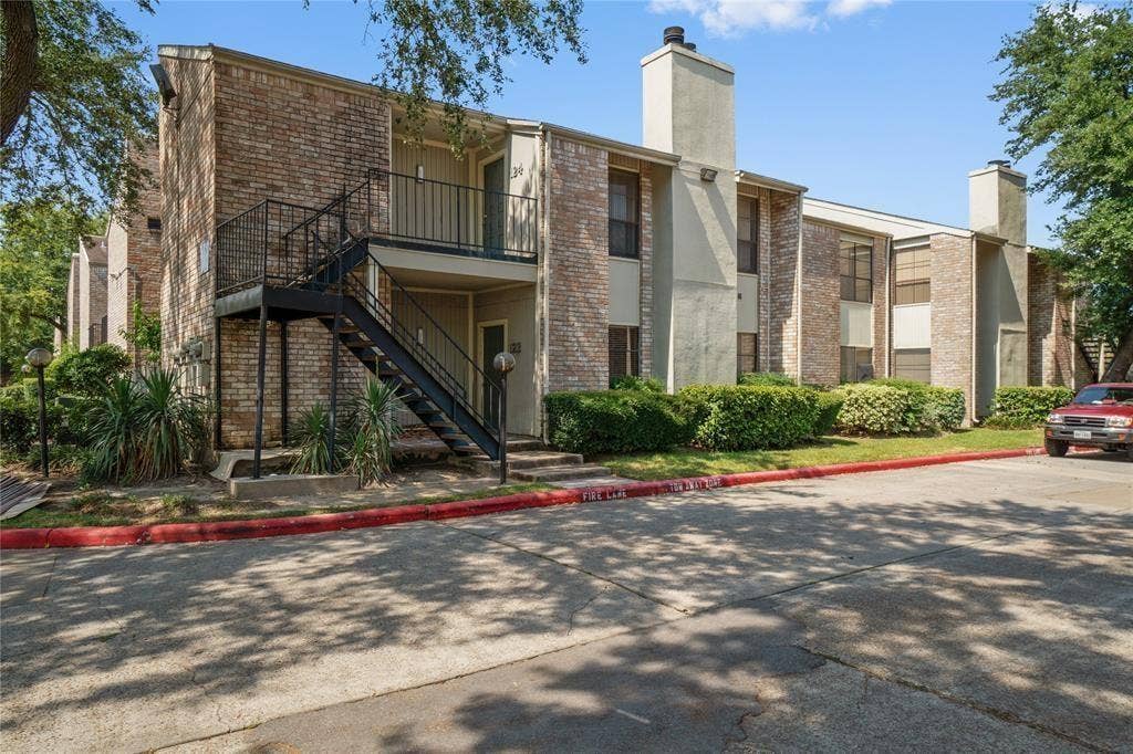 8100 Cambridge Street, #124, Houston, TX 77054 Brick exterior building with multiple units, featuring outdoor metal staircases and railings