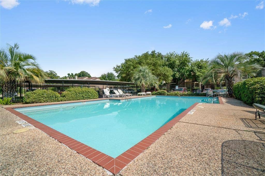 8100 Cambridge Street, #124, Houston, TX 77054 Expansive outdoor swimming pool featuring a brick coping and exposed aggregate decking