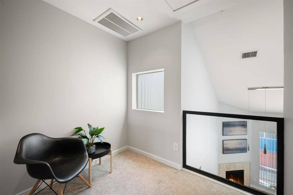 Upper level landing featuring light-colored carpeting and a rectangular frosted window