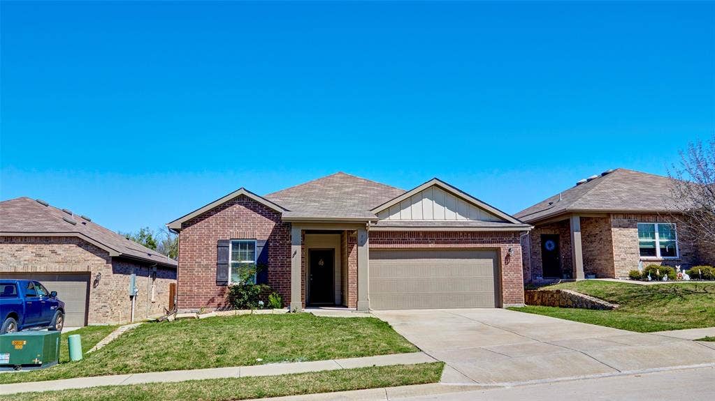 741 Windsor Court, Lavon, TX 75166 Brick exterior with gabled roofline, front-facing garage, concrete driveway, and covered entry