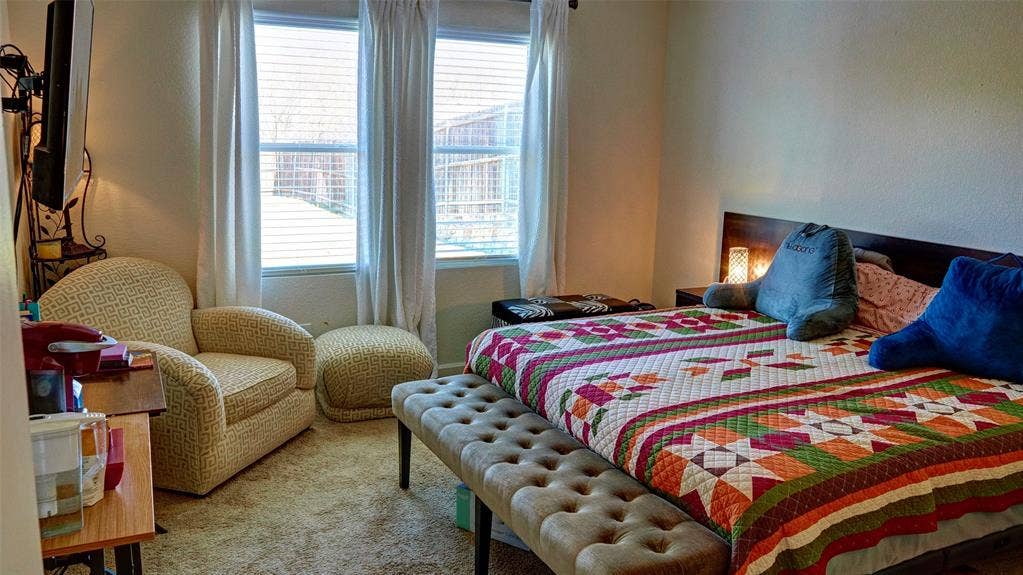 741 Windsor Court, Lavon, TX 75166 Carpeted bedroom with a built-in headboard and integrated side tables