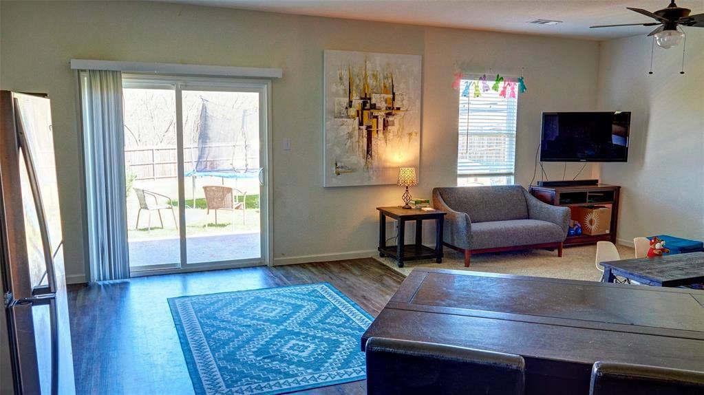 741 Windsor Court, Lavon, TX 75166 Wood-finish flooring, sliding glass patio door, ceiling fan, and window with blinds