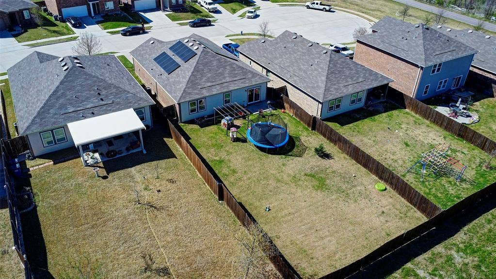 741 Windsor Court, Lavon, TX 75166 Expansive backyard featuring a wood privacy fence, a covered patio, and a shingled roof