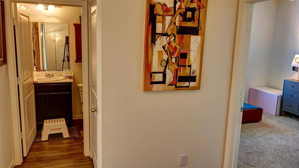 741 Windsor Court, Lavon, TX 75166 Bathroom featuring a vanity with an integrated sink and wood-finish flooring