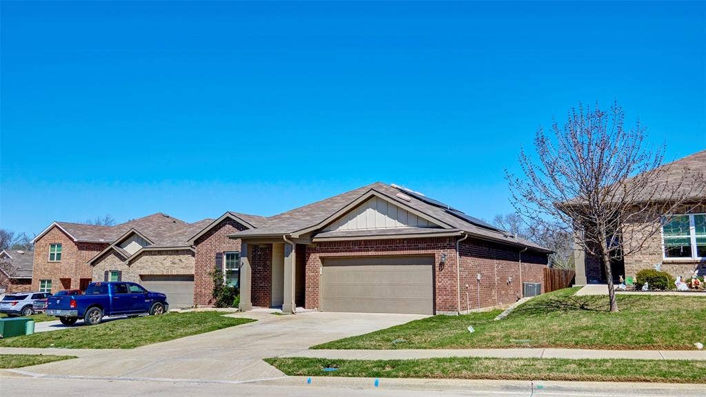 741 Windsor Court, Lavon, TX 75166 Brick exterior with an attached garage, covered entryway, and asphalt shingle roof