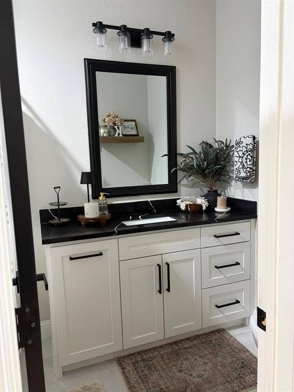 600 Lucas Drive, Athens, TX 75751 White shaker vanity with black countertop and integrated sink
