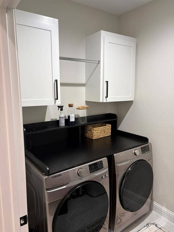600 Lucas Drive, Athens, TX 75751 Laundry area featuring white shaker-style cabinetry with matte black hardware, a black countertop, and an integrated drying rod