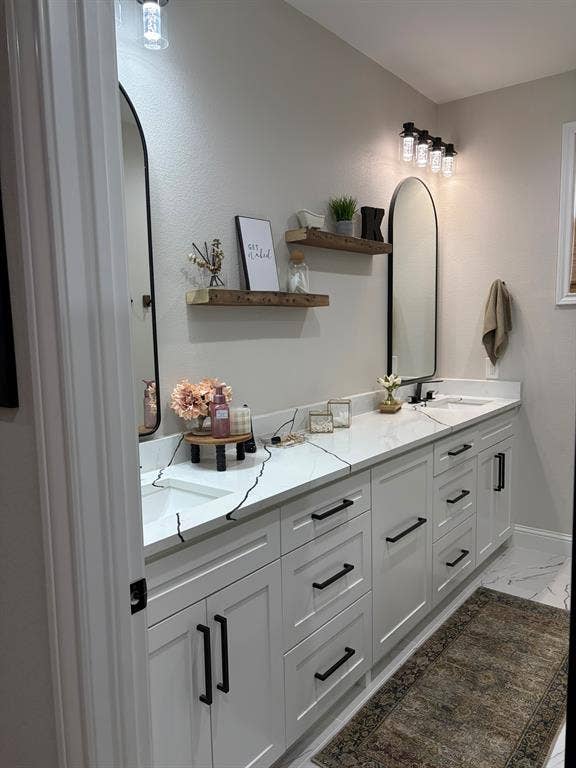 600 Lucas Drive, Athens, TX 75751 Bathroom featuring a dual vanity with white cabinetry, black hardware, and white countertops with black veining